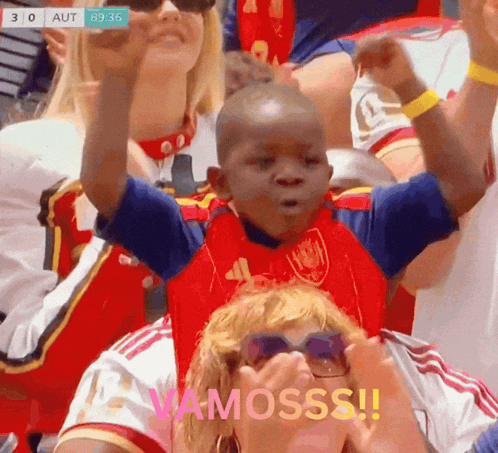 A Young Boy In A Red And Blue Shirt With The Word Vamosss On The Bottom GIF