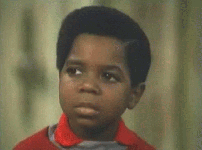 Boy In Red Shirt Making Funny Face Asking What You Talkin Bout GIF