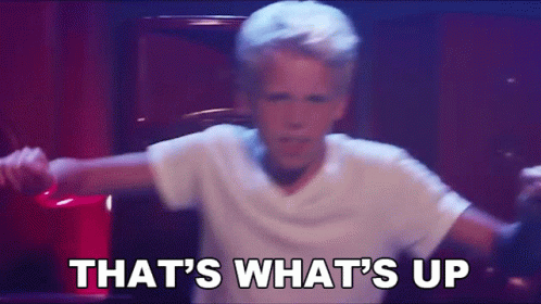 A Young Boy In A White Shirt Is Dancing With The Words That 'S What 'S Up . GIF
