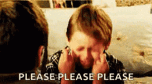 A Young Boy Is Covering His Face With His Hands And A Man Is Behind Him . GIF