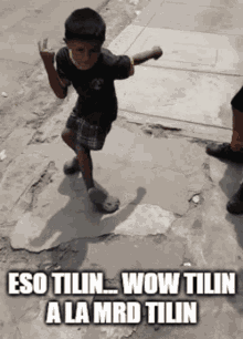 A Young Boy Is Dancing On The Sidewalk With The Words Wow Tilin A La Mrd Tilin GIF