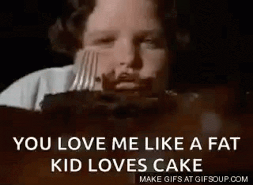 A Young Boy Is Eating A Cake With A Fork . GIF