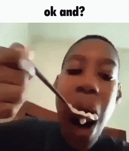 A Young Boy Is Eating A Spoonful Of Cereal With The Words Ok And Written Above Him . GIF