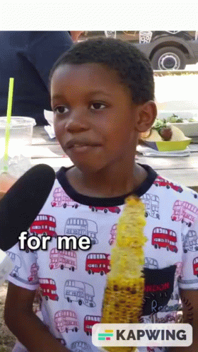 A Young Boy Is Eating Corn On The Cob And The Words For Me Are On The Bottom GIF