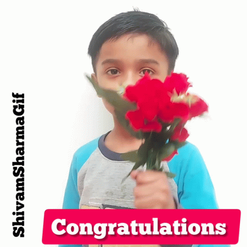 A Young Boy Is Holding A Bouquet Of Red Flowers In Front Of His Face With A Congratulations Sign Below Him GIF