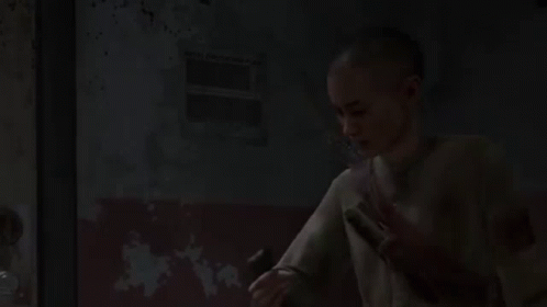 A Young Boy Is Holding A Flashlight In His Hand In A Dark Room . GIF