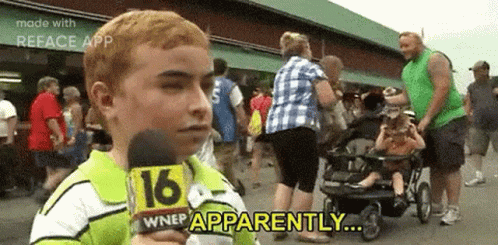 A Young Boy Is Holding A Microphone In Front Of A Crowd Of People And Says `` Apparently '' . GIF