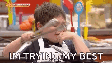 A Young Boy Is Holding A Pair Of Tongs In His Hand And Saying `` I 'M Trying My Best '' GIF