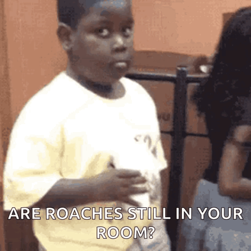 A Young Boy Is Holding A Piece Of Paper And Asking If There Are Roaches Still In His Room . GIF