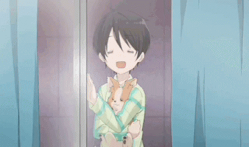 A Young Boy Is Holding A Small Dog In His Arms . GIF