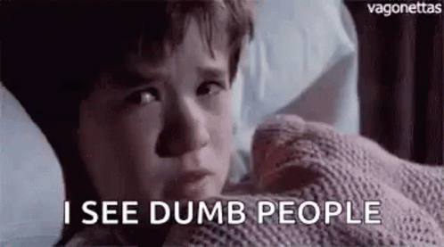 A Young Boy Is Laying In Bed With A Blanket On His Face And Says `` I See Dumb People '' . GIF