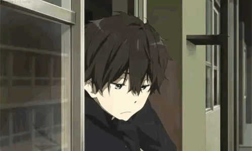 a young boy is looking out of a window .