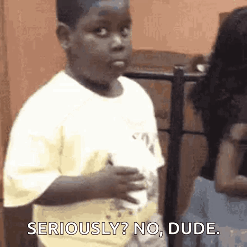 a young boy is making a funny face and saying seriously no dude