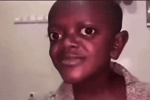 A Young Boy Is Making A Funny Face While Looking At The Camera In A Bathroom . GIF