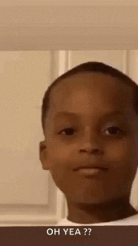 A Young Boy Is Making A Funny Face While Standing In Front Of A Window . GIF
