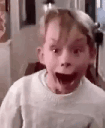 A Young Boy Is Making A Funny Face With His Mouth Open And His Eyes Closed . GIF