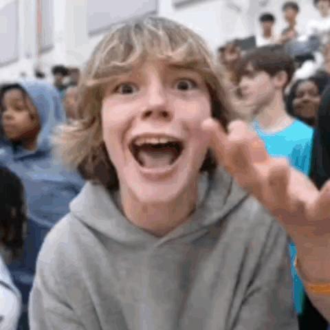 Boy Making Funny Face In Crowd GIF