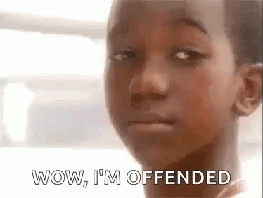 A Young Boy Is Making A Funny Face With The Words Wow , I 'M Offended . GIF