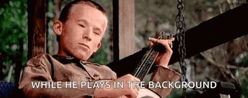 Boy Playing Guitar On Swing GIF