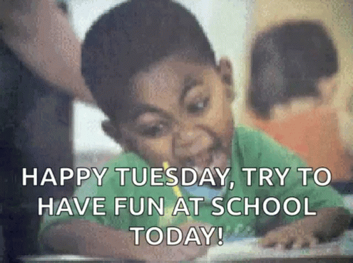 A Young Boy Is Sitting At A Desk In A Classroom . GIF