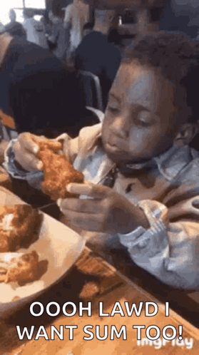 A Young Boy Is Sitting At A Table Eating Fried Chicken With A Fork . GIF