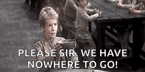 A Young Boy Is Sitting At A Table Holding A Pot Of Soup And A Spoon . GIF