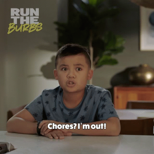 A Young Boy Is Sitting At A Table With The Words Chores I 'M Out GIF