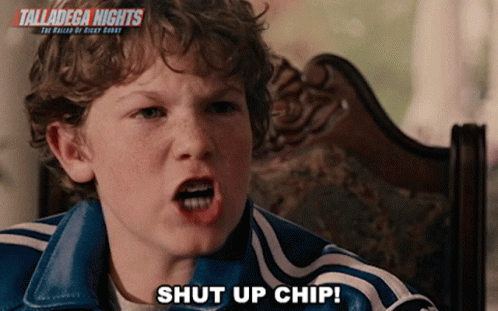 A Young Boy Is Sitting In A Chair With The Words Talladega Nights Behind Him GIF