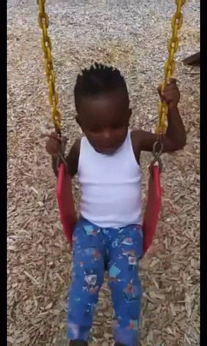 Boy Sitting On Swing In Playground GIF