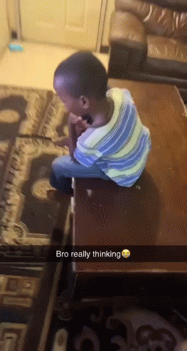 A Young Boy Is Sitting On A Table With The Words Bro Really Thinking Above Him GIF