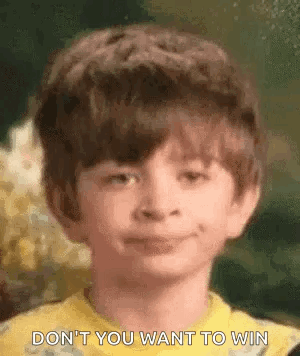 A Young Boy Is Smiling And Making A Funny Face . GIF