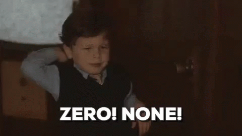 A Young Boy Is Standing In A Dark Room With His Hands Behind His Head . GIF