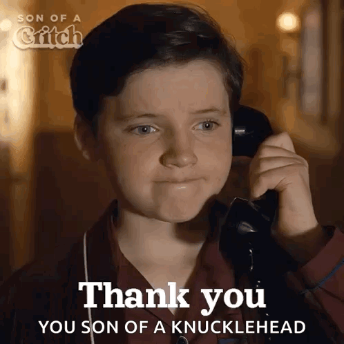 A Young Boy Is Talking On A Phone And Says " Thank You " GIF