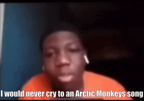 A Young Boy Is Wearing Ear Buds And Says I Would Never Cry To An Arctic Monkeys Song GIF