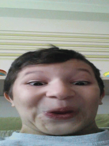 A Young Boy Making A Funny Face With His Mouth Wide Open GIF
