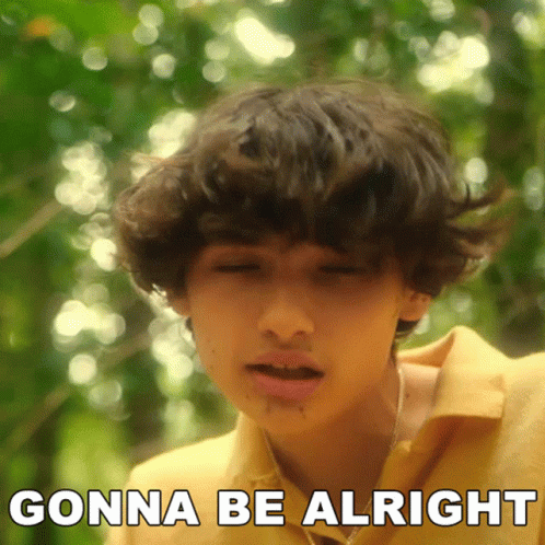 a young boy says gonna be alright in front of a blurry background