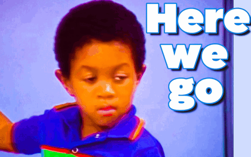 A Young Boy Stands In Front Of A Wall That Says Here We Go GIF