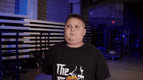 A Young Boy Wearing A Black T-Shirt That Says The Godfather On It GIF