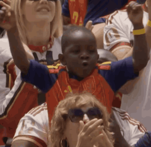 A Young Boy Wearing A Blue And Red Jersey With The Number 1 On It GIF