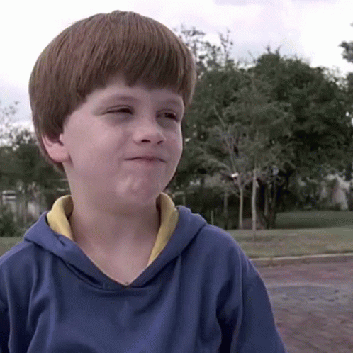A Young Boy Wearing A Blue Hoodie With A Yellow Collar GIF