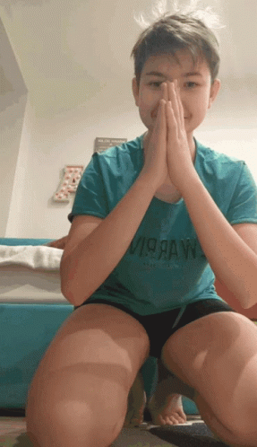 A Young Boy Wearing A Blue Shirt That Says Virraw On It GIF