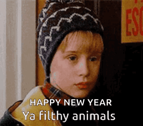 A Young Boy Wearing A Hat Says Happy New Year Ya Filthy Animals .. GIF