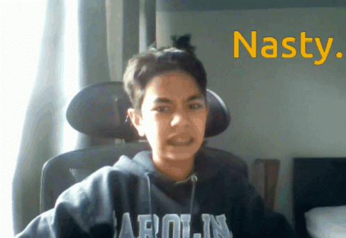 A Young Boy Wearing A Hoodie That Says Arolin Is Sitting In A Chair GIF