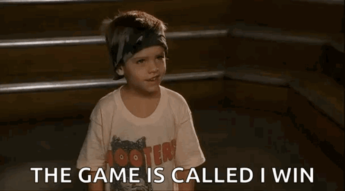 A Young Boy Wearing A Hooters T-Shirt Is Sitting On A Set Of Stairs And Talking . GIF