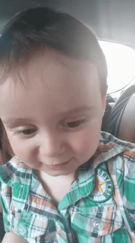 A Young Boy Wearing A Plaid Shirt Has A Patch On His Shirt That Says Cowboys GIF