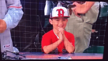 A Young Boy Wearing A Red Shirt And A White Hat With The Letter B On It GIF