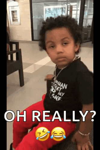 A Young Boy Wearing A Shirt That Says " Oh Really " GIF