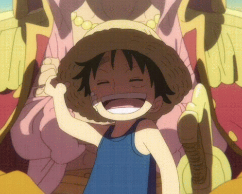 A Young Boy Wearing A Straw Hat And A Blue Tank Top Smiles With His Eyes Closed GIF