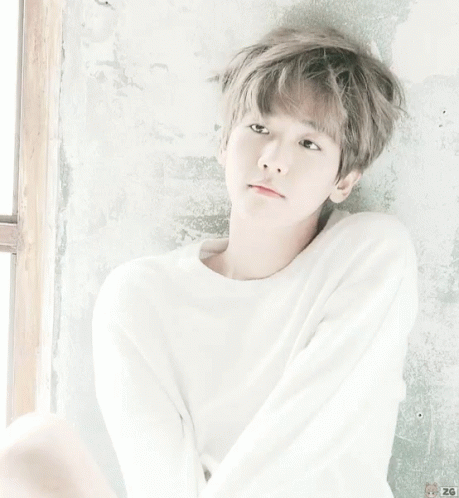A Young Boy Wearing A White Sweater With The Number 26 On It GIF