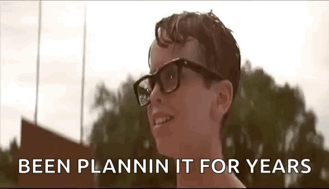 A Young Boy Wearing Glasses Is Smiling With The Words `` Been Plannin It For Years '' Behind Him . GIF